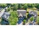 Aerial view showcases the property, surrounding homes, and lush green neighborhood at 556 Georgia Cir, Loganville, GA 30052
