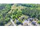 Aerial view of a landscaped home in a neighborhood with lush surrounding nature at 556 Georgia Cir, Loganville, GA 30052