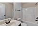 Bright bathroom featuring a tub-shower combo and a sleek vanity at 556 Georgia Cir, Loganville, GA 30052