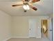 Bedroom features neutral color scheme, ceiling fan, and natural light from the double-hung window with wood blinds at 556 Georgia Cir, Loganville, GA 30052