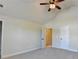 Bright, carpeted bedroom with a ceiling fan, vaulted ceiling, and neutral paint at 556 Georgia Cir, Loganville, GA 30052