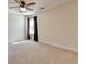 Bedroom showcasing a ceiling fan, natural light, and neutral carpeting at 556 Georgia Cir, Loganville, GA 30052