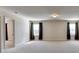 Spacious bonus room featuring carpeted floors, recessed lighting, and multiple windows with curtains at 556 Georgia Cir, Loganville, GA 30052