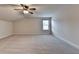 Bonus room with neutral carpet, lots of space, and a ceiling fan at 556 Georgia Cir, Loganville, GA 30052