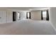 Spacious bonus room with neutral carpeting, natural light and two windows at 556 Georgia Cir, Loganville, GA 30052