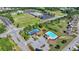 Aerial view of the community pool and tennis courts with lush greenery and ample parking at 556 Georgia Cir, Loganville, GA 30052
