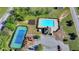 An aerial view of a refreshing community pool with a playground and tennis court nearby at 556 Georgia Cir, Loganville, GA 30052