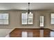 Bright dining area with hardwood floors, large windows, and elegant chandelier at 556 Georgia Cir, Loganville, GA 30052