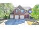 Charming brick home featuring a three-car garage and well-maintained landscaping at 556 Georgia Cir, Loganville, GA 30052