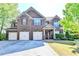 Handsome brick home with an attached three car garage and manicured lawn and garden at 556 Georgia Cir, Loganville, GA 30052