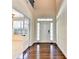 Bright foyer with hardwood floors, transom windows, and a glimpse into an adjacent living space at 556 Georgia Cir, Loganville, GA 30052