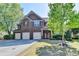 Inviting brick front porch with manicured landscaping, covered entrance and double doors at 556 Georgia Cir, Loganville, GA 30052