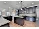 Spacious kitchen features dark cabinetry, granite countertops and stainless steel appliances at 556 Georgia Cir, Loganville, GA 30052