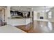 Modern kitchen with granite countertops, dark cabinetry, stainless steel appliances, and hardwood flooring at 556 Georgia Cir, Loganville, GA 30052