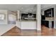 Elegant kitchen featuring granite counters, dark cabinets, and an open layout that connects to the living space at 556 Georgia Cir, Loganville, GA 30052