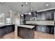 Spacious kitchen features dark cabinetry, granite countertops and stainless steel appliances at 556 Georgia Cir, Loganville, GA 30052