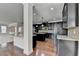Contemporary kitchen boasts granite counters, dark cabinetry, stainless steel appliances, and hardwood floors at 556 Georgia Cir, Loganville, GA 30052