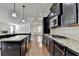 Gourmet kitchen features custom cabinets, granite counters, gas range, and hardwood floors at 556 Georgia Cir, Loganville, GA 30052