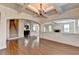 Open-concept living room features hardwood floors, coffered ceilings, and arched doorways at 556 Georgia Cir, Loganville, GA 30052
