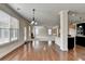 Bright living area with hardwood floors leading to kitchen with granite counters, dark cabinets, and natural light at 556 Georgia Cir, Loganville, GA 30052