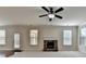 Living room featuring a fireplace, large windows, and a door leading to the outside at 556 Georgia Cir, Loganville, GA 30052