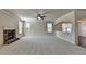 Inviting living room with stone fireplace, neutral carpeting, and plenty of natural light from surrounding windows at 556 Georgia Cir, Loganville, GA 30052