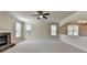 Spacious living room with fireplace, large windows, and neutral paint for a calming atmosphere at 556 Georgia Cir, Loganville, GA 30052
