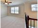 Carpeted loft area with neutral tones, natural light, and classic trim at 556 Georgia Cir, Loganville, GA 30052