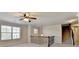 Bright loft area with iron railing, view of staircase, and large windows for natural light at 556 Georgia Cir, Loganville, GA 30052