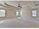Spacious main bedroom with coffered ceilings, neutral walls and carpet, and abundant natural light from the windows at 556 Georgia Cir, Loganville, GA 30052