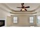 Large main bedroom features a fireplace, coffered ceiling with fan and large windows at 556 Georgia Cir, Loganville, GA 30052