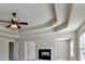 Bright, spacious main bedroom with fireplace, ceiling fan and view into other areas of the home at 556 Georgia Cir, Loganville, GA 30052