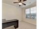 Neutral office with a ceiling fan and window bringing in natural light at 556 Georgia Cir, Loganville, GA 30052