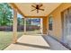 View of the covered patio with ceiling fan overlooking the spacious backyard at 556 Georgia Cir, Loganville, GA 30052
