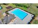 Aerial view of a community pool with a concrete pool deck, bordered by manicured bushes at 556 Georgia Cir, Loganville, GA 30052