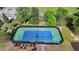 Overhead view of the community's tennis court, enclosed in a black chain link fence at 556 Georgia Cir, Loganville, GA 30052