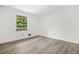 Bedroom with hardwood floors and large window at 7582 Carlisle Dr, Jonesboro, GA 30236