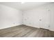 Bedroom featuring three white doors and hardwood floors at 7582 Carlisle Dr, Jonesboro, GA 30236