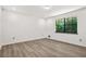 Bedroom with hardwood floors and view of backyard at 7582 Carlisle Dr, Jonesboro, GA 30236