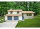 Charming two-story home featuring a two-car garage, front porch and freshly cut grass at 7582 Carlisle Dr, Jonesboro, GA 30236