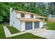 Two-story home with a two-car garage, green lawn, and well-maintained landscape at 7582 Carlisle Dr, Jonesboro, GA 30236