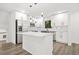 Modern kitchen with a large island, stainless steel appliances, and white cabinets at 7582 Carlisle Dr, Jonesboro, GA 30236
