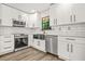 Modern kitchen with stainless steel appliances and white cabinetry at 7582 Carlisle Dr, Jonesboro, GA 30236