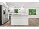Modern kitchen with a large island, stainless steel appliances, and white cabinets at 7582 Carlisle Dr, Jonesboro, GA 30236