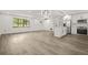 Open-concept living space with hardwood floors and a modern kitchen at 7582 Carlisle Dr, Jonesboro, GA 30236