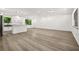 Bright, open-concept living area with hardwood floors and a modern kitchen at 7582 Carlisle Dr, Jonesboro, GA 30236