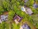Aerial view of property featuring a pool, patio, mature trees, and neighborhood at 9395 Clublands Dr, Alpharetta, GA 30022