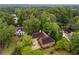 Aerial view of home featuring mature trees, landscaping, and neighborhood at 9395 Clublands Dr, Alpharetta, GA 30022