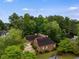Aerial view showcasing the roof and driveway surrounded by lush greenery at 9395 Clublands Dr, Alpharetta, GA 30022
