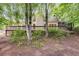 Beautiful backyard with a large deck, mature trees, and lush greenery at 9395 Clublands Dr, Alpharetta, GA 30022